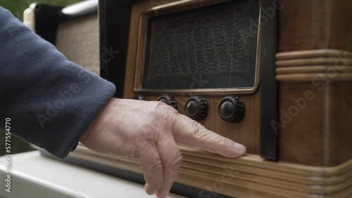 Detail of a man's hand satisfied with his restored antique radio