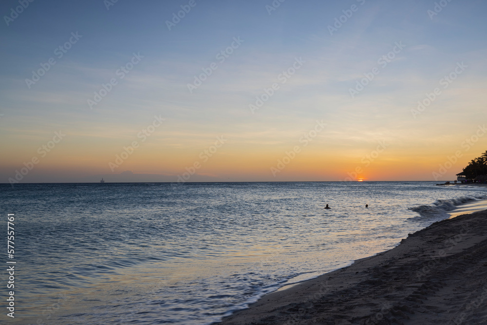 Gorgeous view of sunset on sandy beach of Eagle Beach in Atlantic Ocean on Aruba island. Gorgeous view of sunset on sandy beach of Eagle Beach in Atlantic Ocean on Aruba island.
