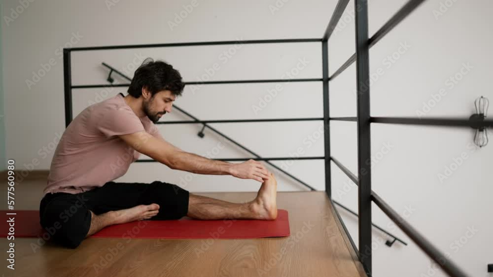 Man stretching at home floor