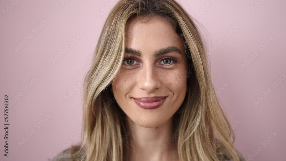 Young blonde woman smiling confident standing over isolated pink background Young blonde woman smiling confident standing over isolated pink background