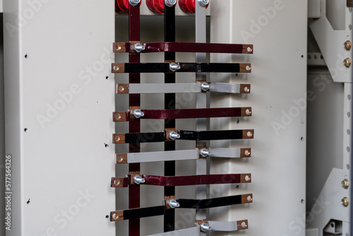 Assemble and install the busbar panel in the electrical system cabinet. photo
