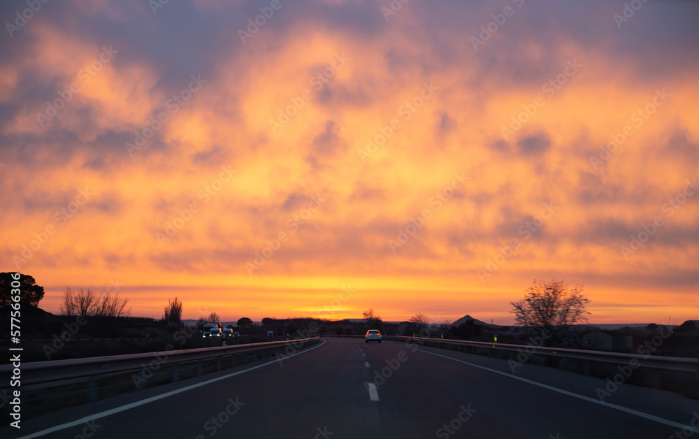 Sunset during the long way of a world trip that opens to us beautiful sky of orange and blue colors of incradible twilight 
