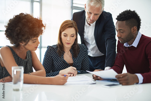 Working with their ideas. Cropped shot of corporate businesspeople in the boardroom.