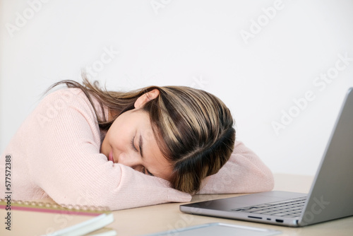 Young asian woman sleeping at her working desk