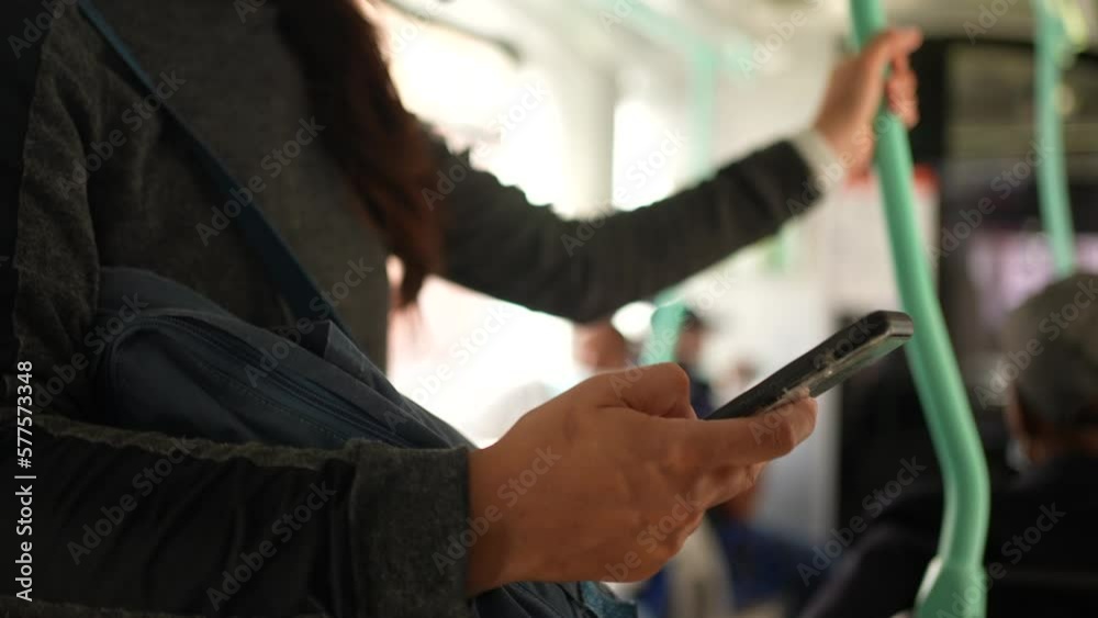 Woman wearing face mask looking at phone inside bus Woman wearing face mask looking at phone inside bus