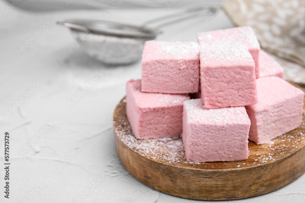 Tasty marshmallows with powder sugar on white textured table, closeup. Space for text Tasty marshmallows with powder sugar on white textured table, closeup. Space for text