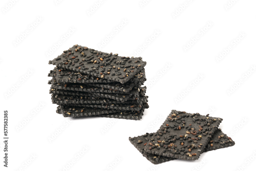 Crackers made of black sesame seeds on a white background