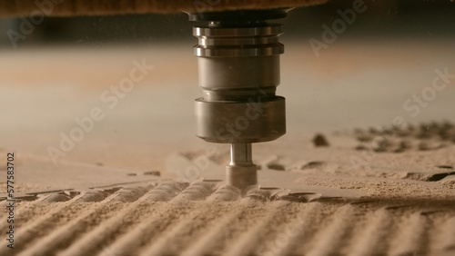 Close-up of automated machine cutting wooden board. Creative. Drill in wood carving machine. Professional machine for industrial carving of wooden products