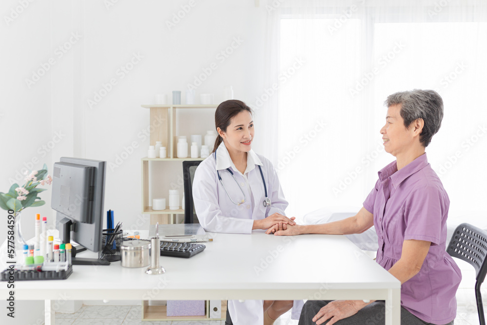 asian female doctor holding hand of old patient in mental health clinic, patient have a problem health in hospital, hand in hand, elderly healthcare promotion asian female doctor holding hand of old patient in mental health clinic, patient have a problem health in hospital, hand in hand, elderly healthcare promotion