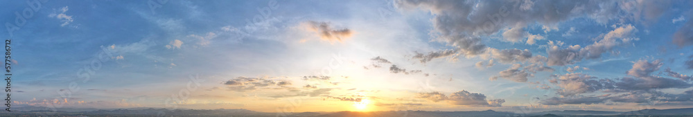 Paranomic sunset with lot of hard blue clouds.