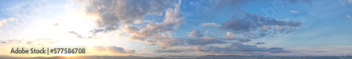 The morning light shines on the soft blue panoramic clouds.