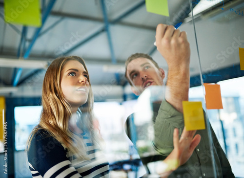 Keeping business evolving with a creative brainstorming session. Shot of colleagues having a brainstorming session with sticky notes at work.