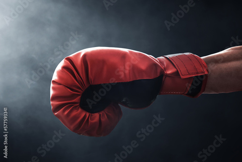 Red boxing gloves on dark background © fotokitas
