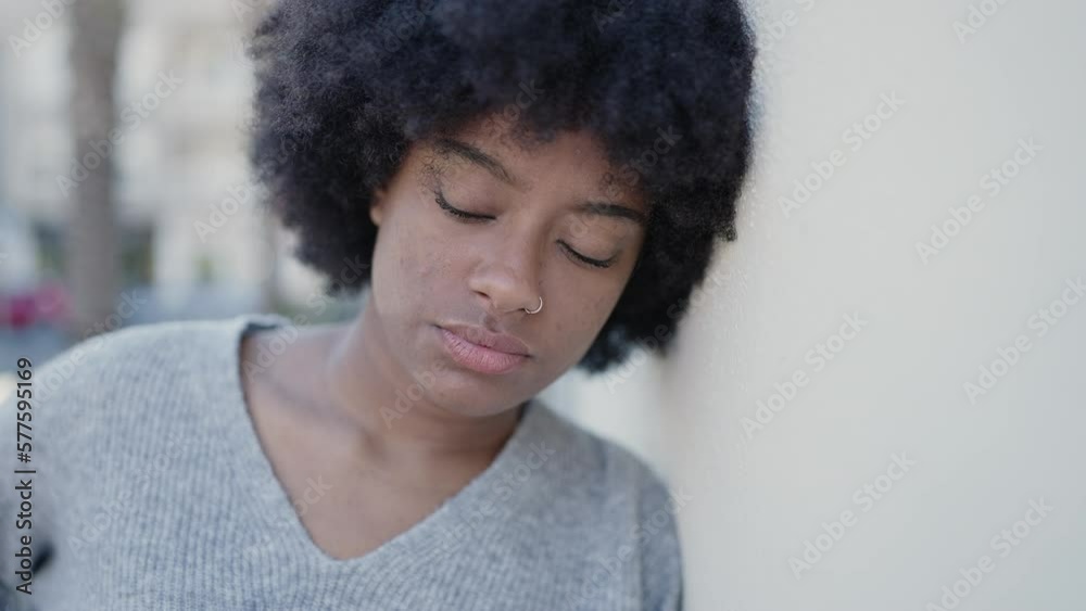 African american woman standing with sad expression at street African american woman standing with sad expression at street