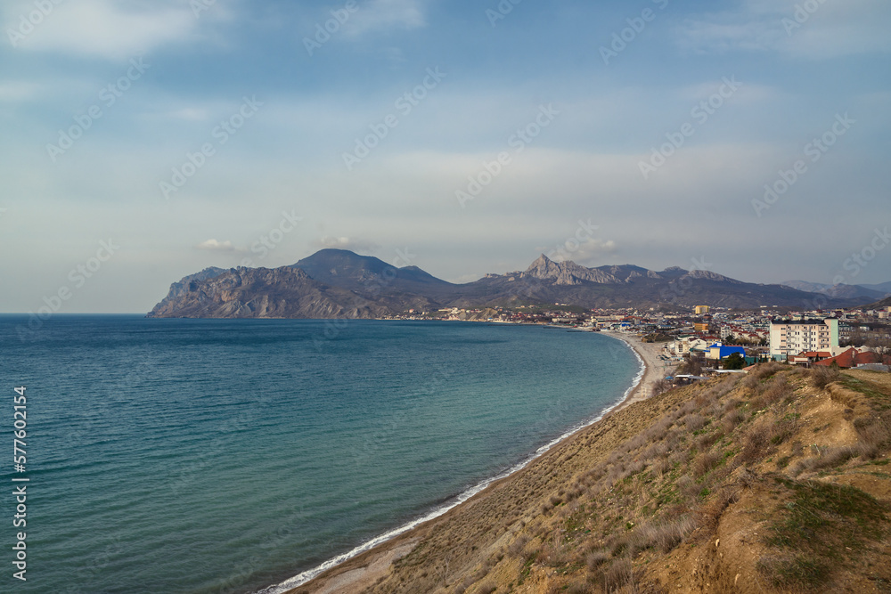 View of seaside resort city Koktebel , mountain Kara Dag from hill in spring. Crimea
