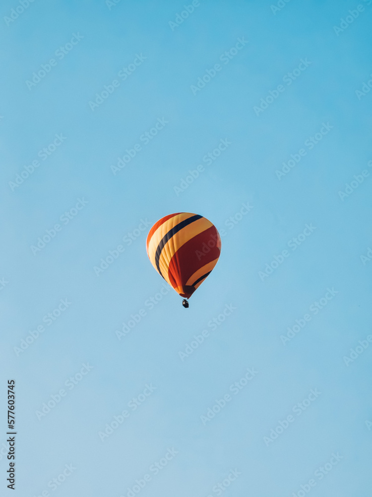 a hot air balloon in the blue sky. a hot air balloon in the blue sky.