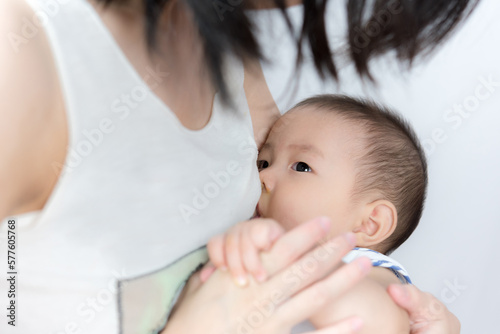Asia baby is happy at breast-feeding time, Asian mom breast feeding her baby boy