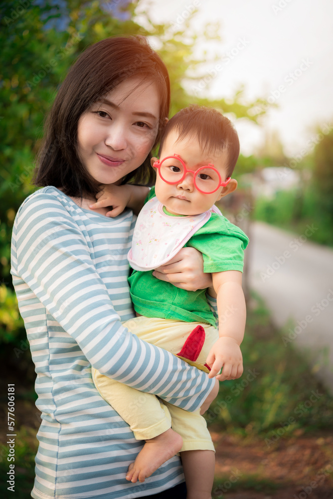 Beautiful young mother and baby, Happy family asia cute baby and mom outdoor, happy mother hug her baby Beautiful young mother and baby, Happy family asia cute baby and mom outdoor, happy mother hug her baby
