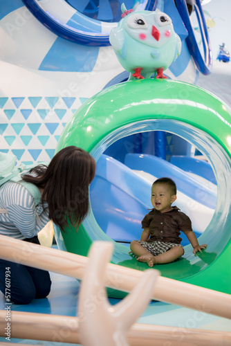 Mother and baby at playground in mall photo