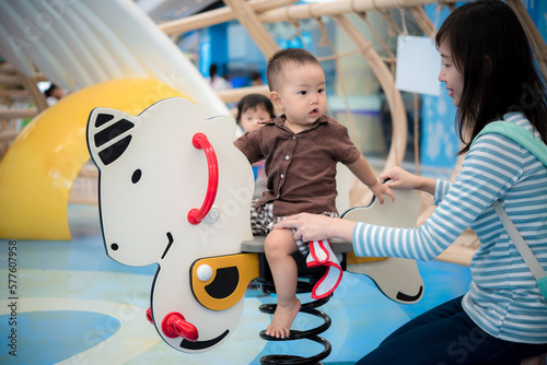 Mother and baby at playground in mall photo