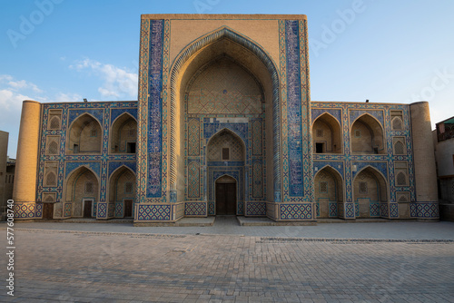 Facade of the ancient Ulugbek madrasah on a sunny morning. Bukhara, Uzbekistan