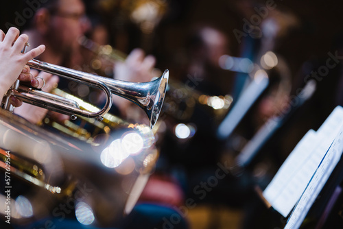 Fotografie A musician playing a trumpet in a trumpet section of an orchestra during rehears