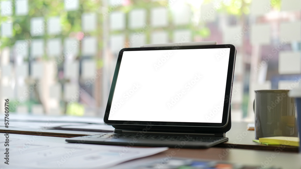 Digital tablet with blank display, document and coffee cup on white office desk. Digital tablet with blank display, document and coffee cup on white office desk.