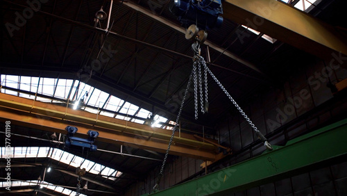 Large metal construction of an industrial crane transporting details. Clip. Heavy machinery background at the factory.