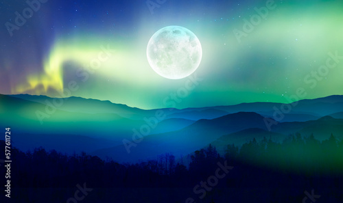Beautiful landscape with blue misty silhouettes of mountains - Northern lights  Aurora borealis  over themountains with super full moon -  Elements of this image furnished by NASA 