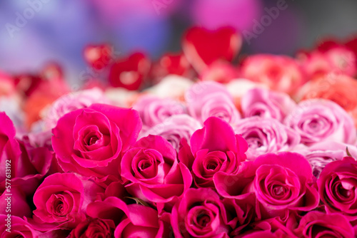 Women   s day concept. Bouquet of red roses on shining table and blue bokeh  background.