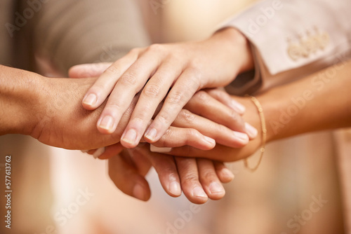 Business people, hands together and unity in trust, collaboration or teamwork at the office. Group piling hand in team building for goal, support or motivation in success, union or cooperation
