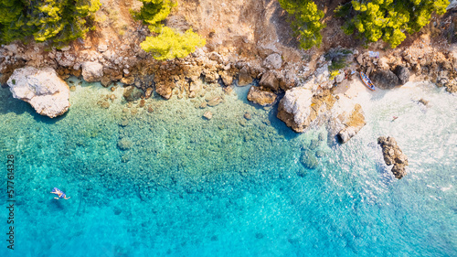 Take in the breathtaking aerial view of Makarska Riviera in Croatia  revealing a picturesque rocky beach and the vibrant turquoise water.