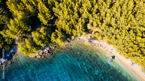 Fototapeta Naklejka Na Ścianę i Meble -  Take in the breathtaking aerial view of Makarska Riviera in Croatia, revealing a picturesque rocky beach and the vibrant turquoise water.