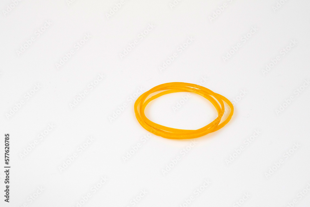 Yellow rubber bands are placed on a white background. Yellow rubber bands are placed on a white background.