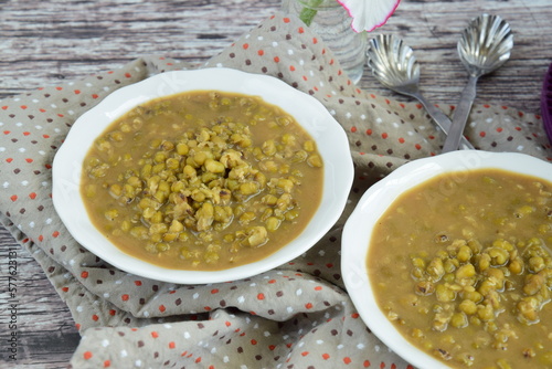 "Bubur kacang hijau" or mung beans porridge is a Malaysian traditional dish usually eat as starter or dessert. Made from mung beans, coconut milk and palm sugar.