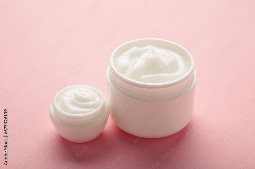 Jar with cream on pink background, space for text Jar with cream on pink background, space for text