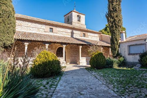 Old stone church with bell tower in the medieval village of Pezuela Torres, Madrid.