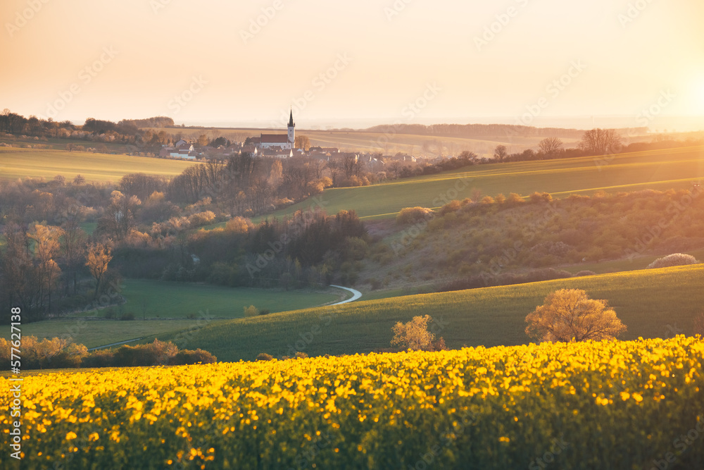 Tranquil view on of sunlit wavy fields of agricultural area. South Moravia region, Czech Republic, Europe. - obrazy, fototapety, plakaty 