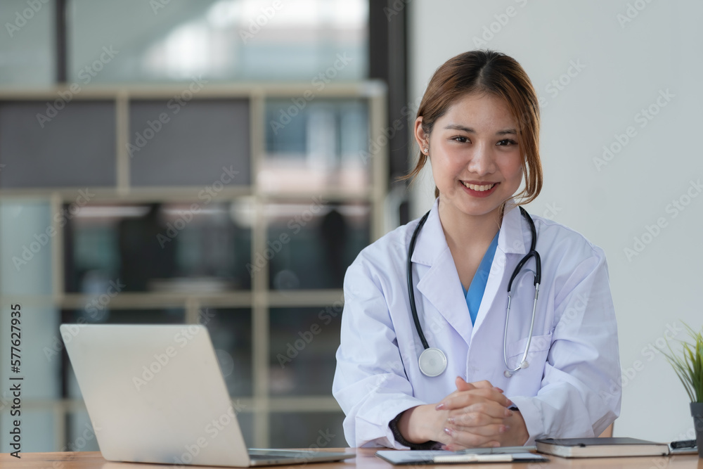 Young beautiful Asian doctor woman working happy and smile in hospital, Asian medical concept Young beautiful Asian doctor woman working happy and smile in hospital, Asian medical concept