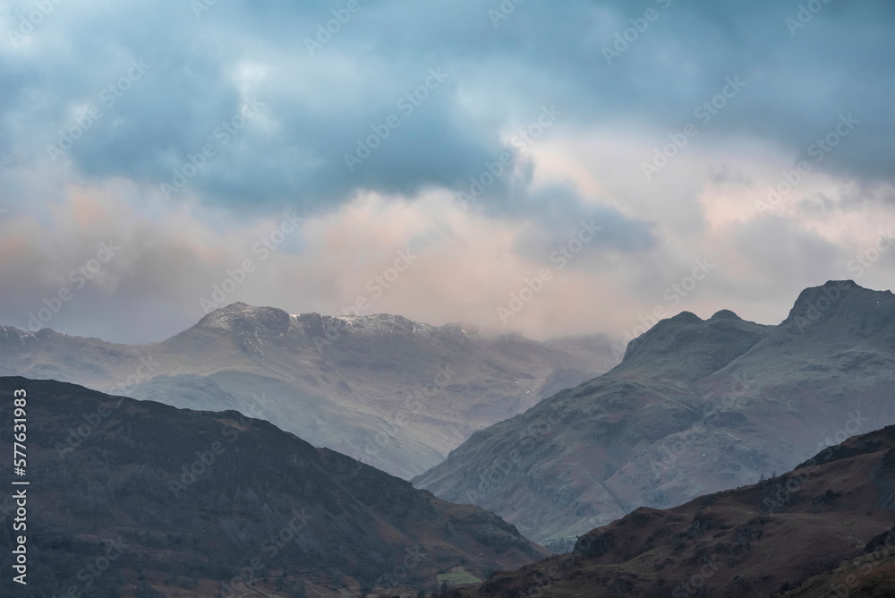 Stunning Winter sunrise landscape view from Loughrigg Fell towards Langdale Pikes and Pike O'Blisco in the Lake District Stunning Winter sunrise landscape view from Loughrigg Fell towards Langdale Pikes and Pike O'Blisco in the Lake District