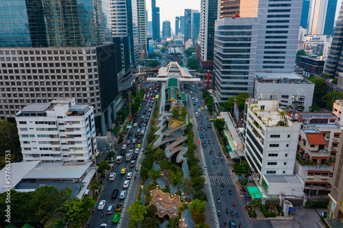 Aerial view of Skywalk Chong Nonsi road intersection with traffic jams on the city skyline at dusk.