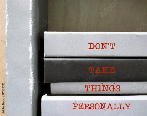 Books spine with text written - Don't Take Things Personally - stop being upset because you think that others are criticizing you in particular, convinced that another person comments are about you photo