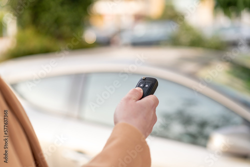 Young blonde woman holding car keys at outdoors