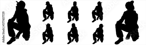 A teenager in a fashionable cap. The boy squatted down. Fashion stylish teenage boys. Children's fashion. Model. Camera view, sideways. Big set of children. Black color silhouettes isolated on white