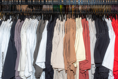 fashion clothing on hangers at the show. Fashionable bright colorful clothes in the wardrobe. spring cleaning concept.