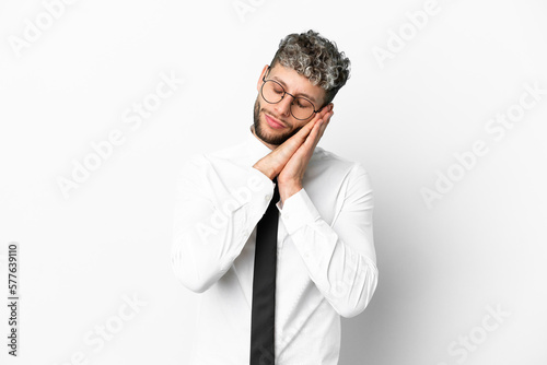 Business caucasian man isolated on white background making sleep gesture in dorable expression