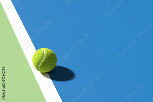 Tennis ball on the edge of the line on blue tennis court. Abstract 3D rendering.