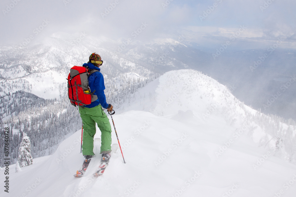 A backcountry skier at the top of a ridge near Columbia Falls, Montana. A backcountry skier at the top of a ridge near Columbia Falls, Montana.