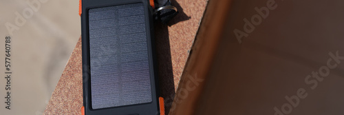 Solar power bank recharging by sunlight outdoor closeup photo