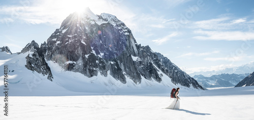 Adventuros bride carries her backpack after getting married on a glacier in Denali National Park. photo